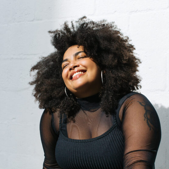 A Smiling Woman With Her Eyes Closed